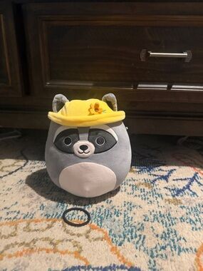 Squishmallows Gray Raccoon Plush with Yellow Flower Hat